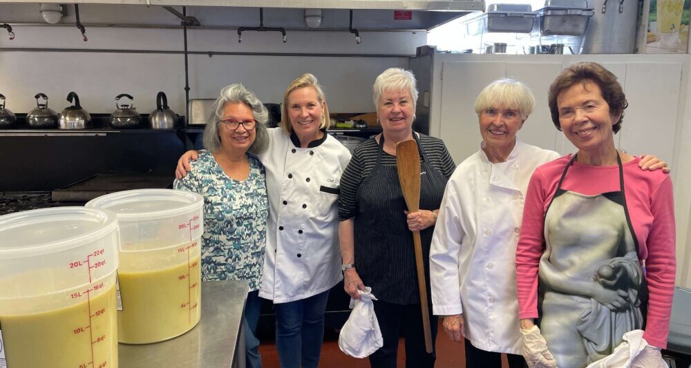 Volunteers at St. Luke Shower Ministry preparing soup for guests.